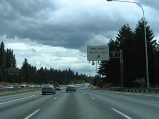 Interstate 5 south enters a diamond interchange for the Metro Transit North Base next. Only transit employees are permitted to use these restricted ramps.