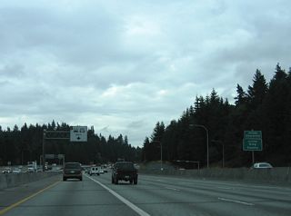 Interstate 5 vacates Snohomish County for King County and the city of Shoreline at the SR 104 under crossing.