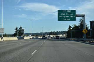 Interstate 5 angles southwest from U.S. 2 and the half diamond interchange (Exit 193) with Pacific Avenue along a freeway varying between an elevated roadway or viaduct to Exit 192 for 41st Street.