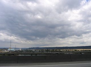 Visible to the west over Steamboat Slough are truss bridges for SR 529 and the adjacent BNSF Railroad. The road bridges opened in 1927 and 1954 respectively.