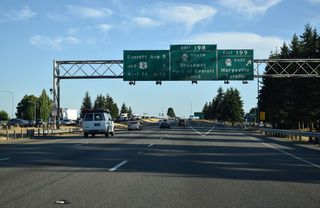Interstate 5 enters the Everett area south of Ebey Slough. Exit 199 departs for SR 528 (4th Street) east and Marine Drive NE west to Priest Point Grange and Tulalip along Possession Sound. Exit 198 follows in one mile for the southbound SR 528 (Broadway).