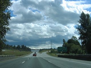 Interstate 5 spans Pilchuck Creek ahead of Exit 210. 236th Street NE links the freeway with Pioneer Highway (old SR 530) north of Silvana. Eastward, 236th Street NE ends at 35th Ave NE amid a mixture of homes and forest stands.