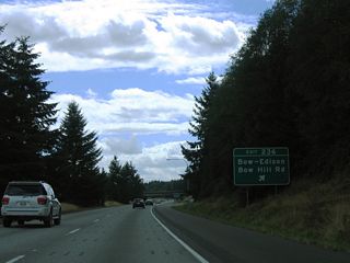 Bow Hill Road lowers onto Jarman Prairie near Belfast to the east, meeting old U.S. 99 opposite from Prairie Road. Bow Hill Road was once a part of SR 237 west of Edison Station. All 9.07 miles of that state route, between SR 11 and SR 20, were decommissioned in 1991 (AARoads Wiki, 2023).