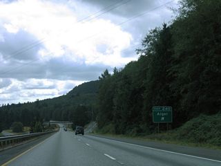 Lake Samish Road continues east from Exit 240 to Old SR 99 (former U.S. 99) and Alger Cain Lake Road at Alger. Alger Cain Lake Road winds northward to Glenhaven and Lake Whatcom.