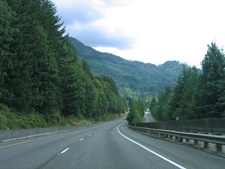 Interstate 5 south and adjacent E Lake Samish Drive (Old U.S. 99) travel between Lake Samish and adjacent Lookout Mountain in this scene.