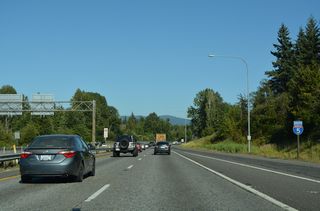 Interstate 5 curves southeast to a parclo interchange (Exit 255) with SR 542 (Sunset Drive).
