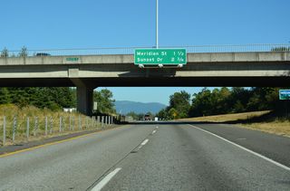 Interstate 5 turns eastward to Exit 256 for SR 539 (Meridian Street). Omitted from this distance sign is Northwest Avenue, the next of the seven Bellingham exits.