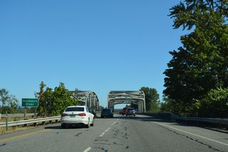 Interstate 5 spans the Nooksack River across a pair of steel through truss bridges.