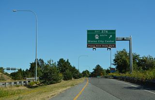The north end of SR 548 ties into a roundabout with D Street east and 2nd Street north to Peace Arch State Park.