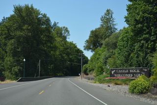 Castle Rock (elevation 190 feet) rises along the Cowlitz River alongside Huntington Avenue north at Buland Drive.