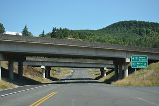 Business Loop I-5 (Huntington Avenue) spans a BNSF Railroad ahead of Pleasant Hill Road (Old U.S. 99) and the diamond interchange (Exit 48) with Interstate 5.