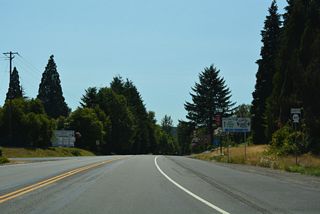 SR 411 begins south alongside Business Loop I-5 from the diamond interchange (Exit 49) joining Interstate 5 with SR 504 east and Huntington Avenue.