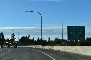 Turning west below grade, SR 16 advances 0.75 miles to Exit 4 for Jackson Avenue.
