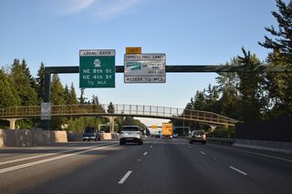 A cloverstack interchange (Exit 14) joins I-405/SR 520 in a valley between the Ashwood and Northrup neighborhoods.