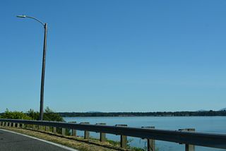 The south shore of Drayton Harbor stretches west to Semiahmoo Spit. Out of view along Peace Portal Drive is the parallel BNSF Railroad line running adjacent to the shoreline.