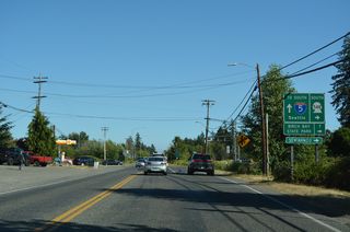 SR 548 turns south from Peace Portal Drive (Historic U.S. 99) onto Bell Road. Bell Road takes the route across nearby Dakota Creek onto Blaine Road south to Birch Bay.