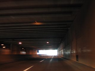 Westbound 14th Avenue SE within the Capitol Campus tunnel. Portals open between the four lane arterial and the parking area on the south side of the structure.