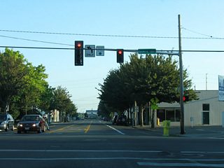 Capitol Way north at State Avenue. State Avenue flows west as the counterpart to 4th Avenue east. State Avenue carried U.S. 99 south from Pacific Avenue after 1949 and until 1958. State Avenue west from Capitol Way represents U.S. 101 north after 1949 as well.