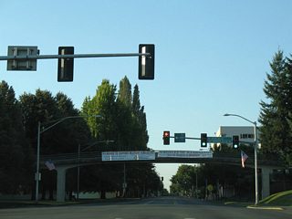 14th Avenue SE and Sid Snyder Avenue come together at Capitol Way near the Capitol Campus Visitor Center (connected by the pedestrian overpass in this photo). 14th Avenue utilizes a cut and cover tunnel to the east, providing direct access to Interstate 5 at Henderson Boulevard.
