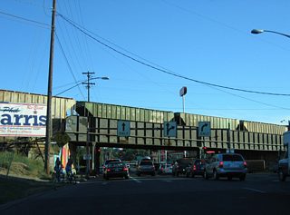 A loop ramp carries drivers from Maple Street south onto 1st Avenue east for the city center while the street splits with Walnut Street as a southbound only roadway to 2nd Avenue. 2nd Avenue, along with 3rd Avenue, represents a couplet eastward parallel to Interstate 90. Westward, the two avenues combine as Sunset Boulevard ahead of Hangman Creek.