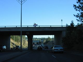 Just beyond the Broadway Avenue overpass is the site of the former toll plaza for the Maple Street Bridge. The Spokane River crossing was tolled until July 13, 1990.26