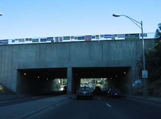 A short tunnel carries Summit Parkway and a wide right of way over the Maple Street Bridge just north of the Spokane River.