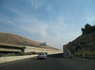 A pair of freeway entrance signs herald the ramp onto U.S. 97.U.S. 97 technically is a freeway through Union Gap only because the steep hill side and parallel Yakima River prevent access points.