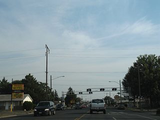 A railroad spur follows H Street east from the parallel BNSF Railroad line to an industrial site at North 7th Street. Several motels and fast food chains line the former U.S. 97 (North 1st Street) southward to the city center.