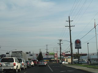 Washington Avenue meets South 1st Street at this traffic light near the retail heavy area centered by Valley Mall. Washington Avenue ventures west to Yakima Air Terminal - McAllister Field (YKM).