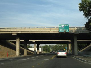The Interstate 82 westbound control point switches from Yakima to Ellensburg on the sign attached to the freeway overpass. Interstate 82 travels north into Yakima on the 40 mile drive to Ellensburg (via Interstate 90).