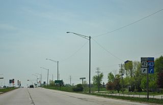 U.S. 151 (Calumet Avenue) passes south of the Manitowoc County Fairgrounds ahead of the diamond interchange with Interstate 43 and Wis 42.