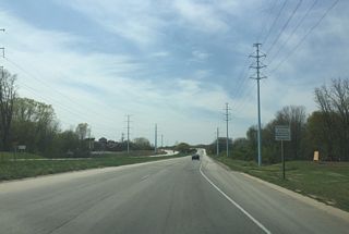Sign prohibiting pedestrians indicating that the freeway starts here. 9th Street north ties into Ashland Avenue north out of view.