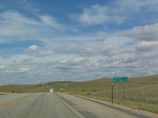 This mileage sign provides the distance to Pine Haven via Wyoming 113 and Devils Tower Junction, which is where U.S. 14 and Wyoming 24 converge. Devils Tower itself is another six miles north of Devils Tower Junction via Wyoming 24 and Wyoming 110.