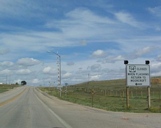 Like other rural roads in the state, U.S. 14 closes during periods of inclement weather. During these times, the lights on this sign will be illuminated, and it is illegal for anyone to drive on the highway while the road is signalized as being closed.