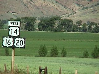 These U.S. 14-16-20 westbound shields are located in Shoshone Canyon west of Cody. Some of the areas in Shoshone Canyon (near Wapiti) are irrigated for agricultural use, while tall mountains surround the valley. West of here, U.S. 14-16-20 enter the Shoshone National Forest, which was the first national forest to be designated in the United States. President Benjamin Harrison created the new national forest on March 30, 1891.