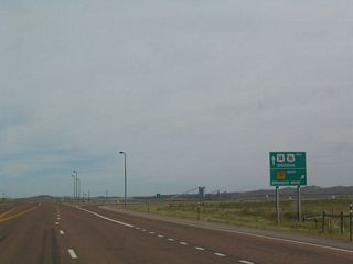 Westbound U.S. 14-16 split from northbound Wyoming 59 northwest of Gillette. U.S. 14-16 continue northwest toward Spotted Horse, Arvada, Leiter, Clearmont, and Ucross. Wyoming 59 travels north toward Broadus, Montana. The Powder River Basin is well known nationally as an area of energy reserves, including coal. The surrounding infrastructure reflects this in many ways, some more subtle than others. According toDiscover America: Wyomingby Nathaniel Burt (1991 edition, page 169), many of the roads in and around Gillette are built of crushed "clinker," which is a red-colored rock that is created when coal is burned underground.