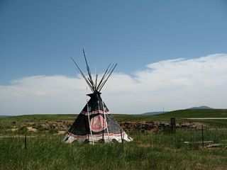 The Vore Buffalo Jump is a major archaeological site located between Old U.S. 14 and Interstate 90 on the north side of the freeway. Discovered when the Interstate 90 freeway was being constructed in the early 1970s, the Vore Buffalo Jump is "a natural sinkhole that was used as a bison trap from about 1500 to 1800 A.D. Buffalo were driven over the edge of the sink hole as a method for the Native American tribes to procure the large quantities of meat and hides needed to survive the harsh prairie winters." Students and scholars frequent the site to excavate old bones and continue to find the remains of animals. A visitors center and excavation site building (opened in July 2011; not shown in this series of pictures) are available on site for visitors for a nominal fee. The teepee makes it easy to locate the buffalo jump when driving by on Interstate 90.