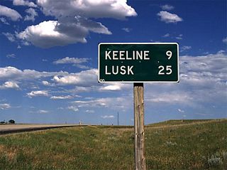 This mileage sign along eastbound U.S. 18 and U.S. 20 provides the distance to Keeline and Lusk.