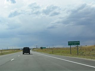 A diamond interchange provides for the connection from U.S. 20-26 to Wyoming 254, Salt Creek Highway. Salt Creek Highway is the old alignment of U.S. 87 (and prior to 1936, it was U.S. 87E). It travels north toward Bar Nunn, and it connects to Business U.S. 20-26 to the south.
