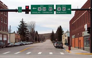 After passing through Van Tassell and Node, U.S. 20 approaches the city of Lusk, which is the seat of Niobrara County. Now entering downtown Lusk, westbound U.S. 20 (3rd Street) reaches its junction with U.S. 18-85 (Cedar Street).