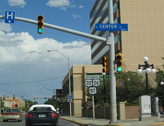 Eastbound U.S. 20-26 Business meets Business Loop I-25/U.S. 87 Business at Center Street in downtown Casper. The first reassurance shield shows the three business U.S. routes, but it omits the green business loop shield.
