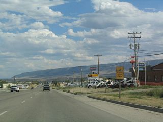 A trailblazer shield for Wyoming 220 is posted after the Old Yellowstone Highway intersection. Wyoming 220 travels southwest from Casper toward Muddy Gap via Alcova, Independence Rock, and Devils Gate. At Muddy Gap, travelers may turn northwest onto U.S. 287/Wyoming 789 toward Lander or turn south on U.S. 287/Wyoming 789 toward Rawlins and Interstate 80 (to Rock Springs, Evanston, and Salt Lake City). To Laramie, follow Wyoming 220 west to Wyoming 487 south to U.S. 30-287 southeast. This is a faster route than using the Interstate Highway System to Laramie.