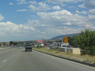 Passing through Mills, eastbound U.S. 20-26 Business (West Yellowstone Highway) approaches Wyoming 258, which serves as the circumferential highway around the western, southern, and eastern edges of the Casper metropolitan area via Wyoming Boulevard.