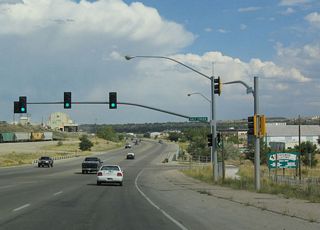With the Burlington Northern and Santa Fe Railroad tracks as a backdrop, eastbound U.S. 20-26 Business meets Wyoming 254 (Salt Creek Highway). Wyoming 254 is the old alignment of U.S. 87. With U.S. 87 relocated onto Interstate 25, the old route is now a secondary state highway.  Wyoming 254 joins Interstate 25/U.S. 87 at Exit 191 near Bar Nunn. Since Business Loop I-25 follows a rather short alignment through Casper, Wyoming 254 is not part of the Interstate Business Loop. However, it would make sense for Business Loop I-25 to follow Wyoming 254 and then turn east through Mills and thence into Casper.