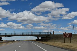 An advance sign references Exit 10 D for Curt Gowdy State Park. The park is located in the Laramie Mountains along WY-210.