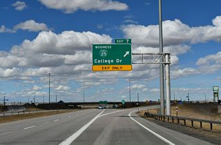 College Drive doubles as WY-212. WY-212 encircles the capital city east to Laramie County Community College and north to I-80 and U.S. 30. Business Loop I-25 overlaps with WY-212, 2.71 miles east to U.S. 85 (Greeley Highway). The business route joins U.S. 85 and I-180 north to Downtown.