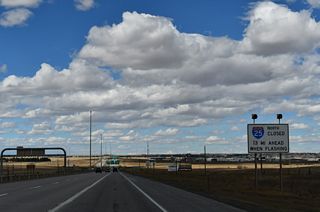 Another advisory sign references the potential closure of I-25 north of Cheyenne due to inclement weather.