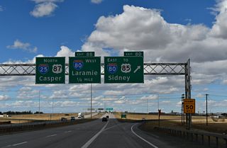 Guide signs for Exit 8 D reference U.S. 85, which coincides with I-180, Business Loop I-25 and U.S. 87 Business at the succeeding exit along Interstate 80 east. I-180 is an at-grade expressway spur north to Downtown Cheyenne.