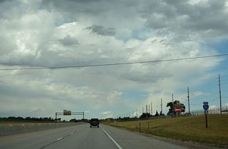 A barrier median separates the roadways of Interstate 25 between F.E. Warren AFB and northwestern Cheyenne neighborhoods.