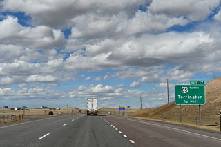 The next exit along northbound is the final separation between I-25/U.S. 87 and U.S. 85. The three routes intertwine to some degree northward from New Mexico. U.S. 85 angles northeast toward Torrington, then travels north along the eastern spine of Wyoming toward Lusk and the Black Hills region of South Dakota